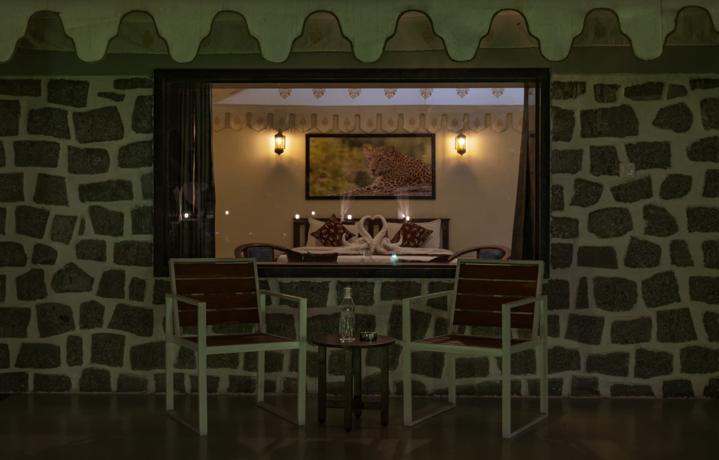 A stone dining pavilion at Upvan Jawai, warmly lit after dark